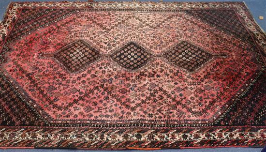 A red ground rug 294 x 215cm
